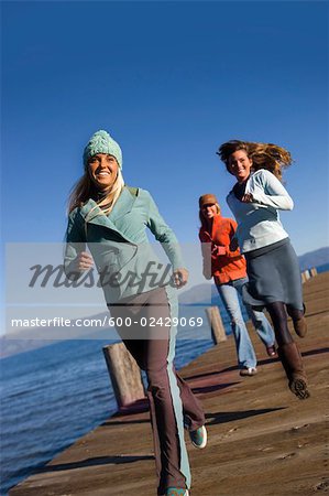 Friends Running on Dock, Lake Tahoe, California, USA