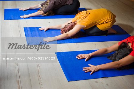 Women in Yoga Class Doing Child Pose