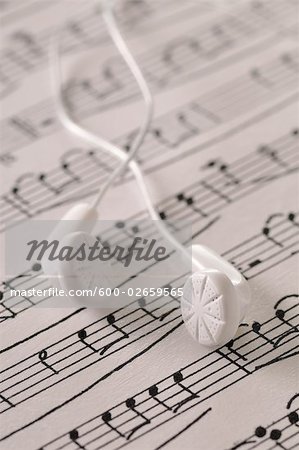 Ear Buds Resting on Sheet Music