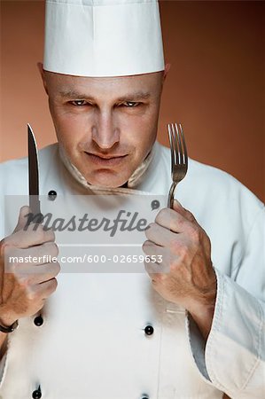 Portrait of Chef Holding Knife and Fork