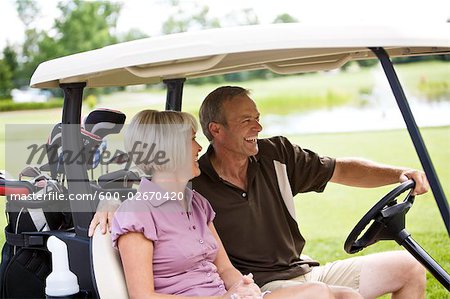 Couple Driving Golf Cart, Burlington, Ontario, Canada