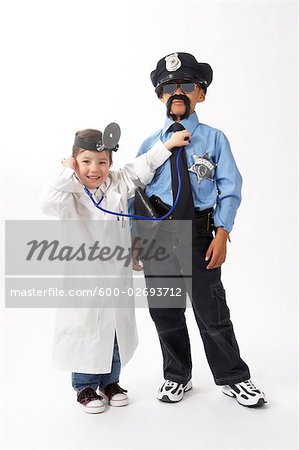 Girl Dressed as Doctor Checking Boy Dressed as Police Officer