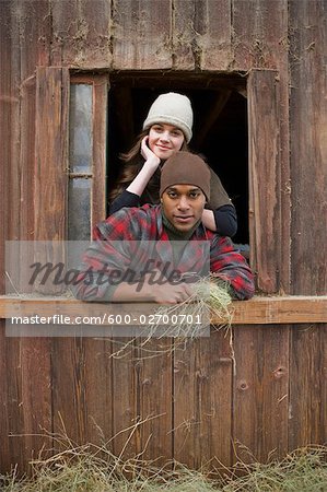Portrait of Couple Leaning Out Barn Window on a Farm in Hillsboro, Oregon, USA