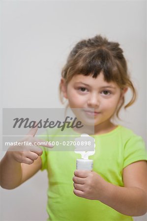 Little Girl Holding Energy Efficient Lightbulb