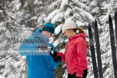 Close-up of Couple Drinking from Thermos, Cross Country Skiing, Whistler, British Columbia, Canada