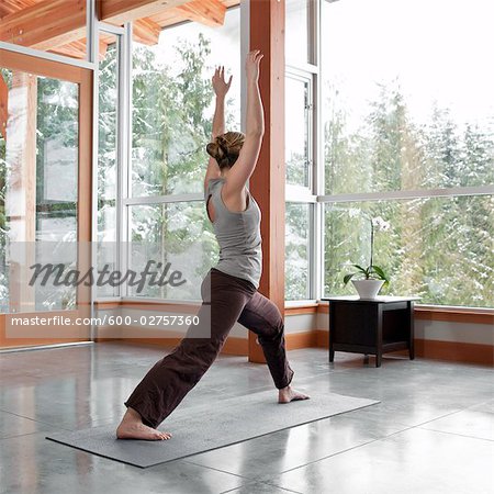 Woman Doing Yoga in Living Room of Large Alpine Home