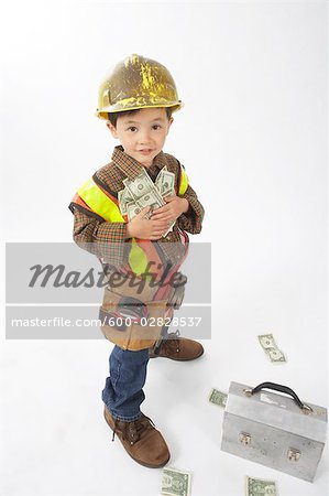 Boy Dressed Up as Construction Worker Holding Money