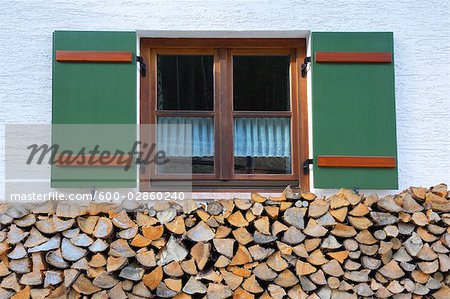 Firewood Stacked in front of Old Window of Farmhouse, Berchtesgaden, Bavaria, Germany
