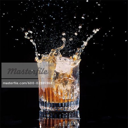 Ice Splashing into a Tumbler of Whiskey