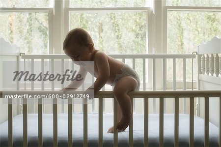 Baby Boy Climbing Out Of Crib Stock Photo Masterfile Premium