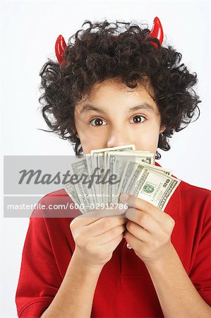 Little Boy Dressed as Devil Holding Cash