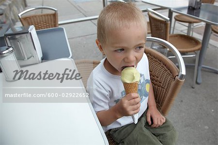 Little Boy Eating Ice Cream on Restaurant Patio