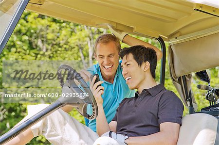 Men in Golf Cart Reading Text Message