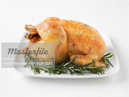 Roast Chicken on Platter With Rosemary Garnish
