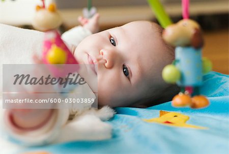 Baby Lying on Blanket with Toys