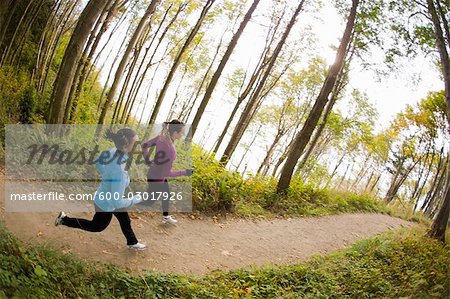 Women Running on Forest Trail, Seattle, Washington, USA