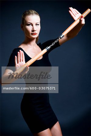 Woman Holding Nunchucks