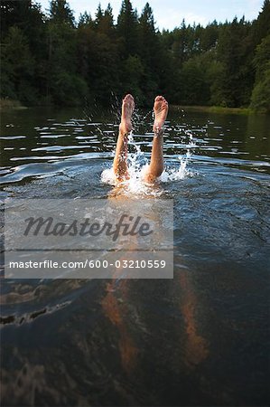 Teenage Girl Diving to the Bottom of the Lake, Near Portland, Oregon, USA