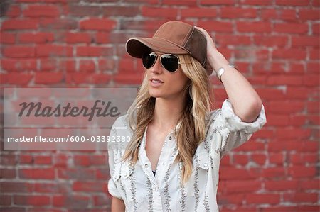 Portrait of Woman Standing in Front of Brick Wall