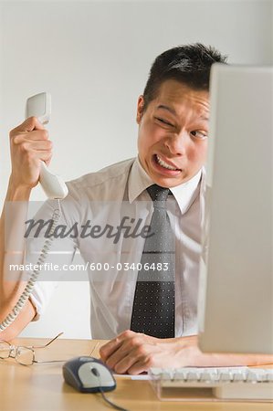 Businessman Being Yelled at Over Telephone