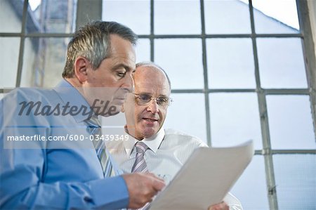 Businessmen Looking at Document