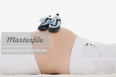 Baby Shoes on Pregnant Woman's Belly