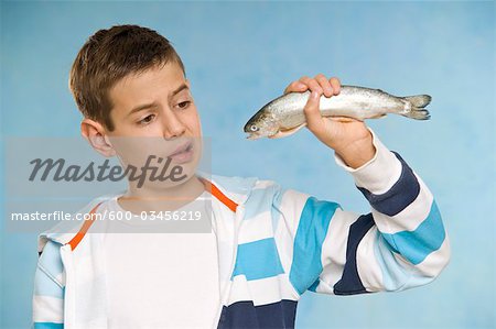 Boy Holding Raw Fish