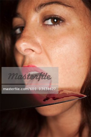 Woman Licking Blood off a Knife