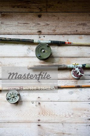 Fishing Rods Hanging on Wall - Stock Photo - Masterfile - Premium