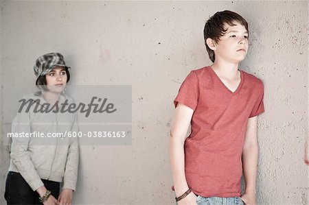 Boy and Girl Leaning on Wall