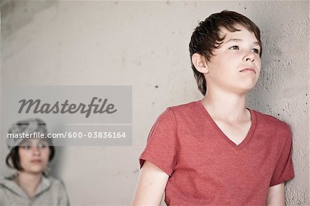 Boy and Girl Leaning on Wall