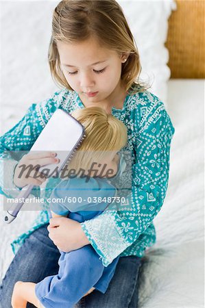 Girl Brushing Doll's Hair