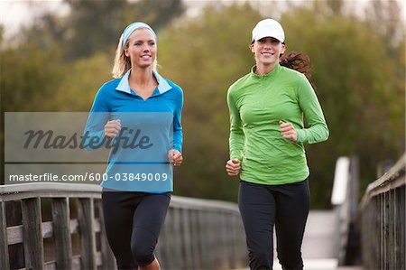 Two Women Jogging through Park