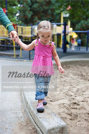 Girl Holding Mom's Hand, Washington Park Playground, Portland, Oregon, USA Girl Holding Mom's Hand, Washington Park Playground, Portland, Oregon, USA