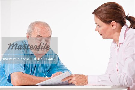 Man and Woman Discussing Paperwork