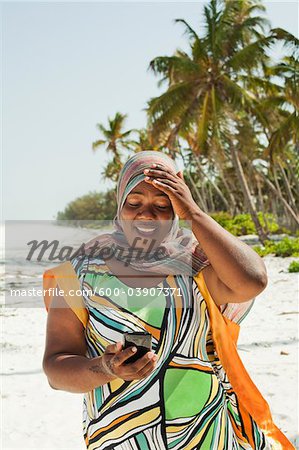 Woman Looking at Snapshots, Nyota Beach, Unguja, Zanzibar, Tanzania Woman Looking at Snapshots, Nyota Beach, Unguja, Zanzibar, Tanzania