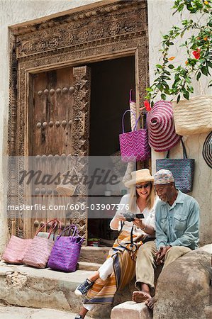 Basket Seller with Tourist, Stone Town, Unguja, Zanzibar, Tanzania Basket Seller with Tourist, Stone Town, Unguja, Zanzibar, Tanzania