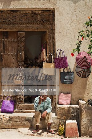 Basket Seller Using Cell Phone, Stone Town, Unguja, Zanzibar, Tanzania