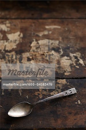 Tarnished Silver Spoon on Wooden Background