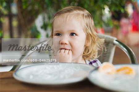 Girl Eating at Table