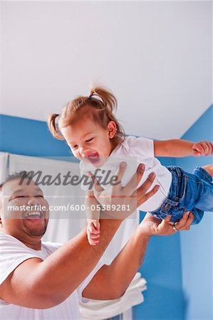 Father Lifting Daughter into the Air