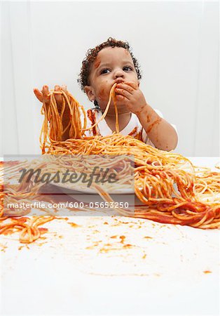 Boy eating Spaghetti with Hands