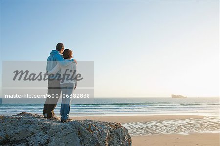 Mature Couple Looking into the Distance on the Beach, Camaret-sur-Mer, Crozon Peninsula, Finistere, Brittany, France