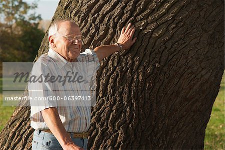 Man Standing by Tree, Lampertheim, Hesse, Germany