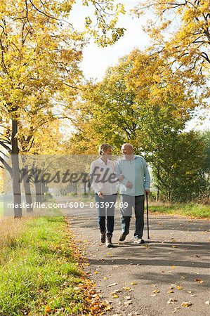 Mature Woman Walking with Senior Father in Autumn, Lampertheim, Hesse, Germany