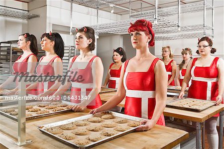 Women Wearing Devil Horns Working at a Bakery, Oakland, Alameda County, California, USA Women Wearing Devil Horns Working at a Bakery, Oakland, Alameda County, California, USA