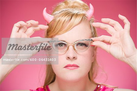 Portrait of Woman Wearing Devil Horns and Vintage Eyeglasses