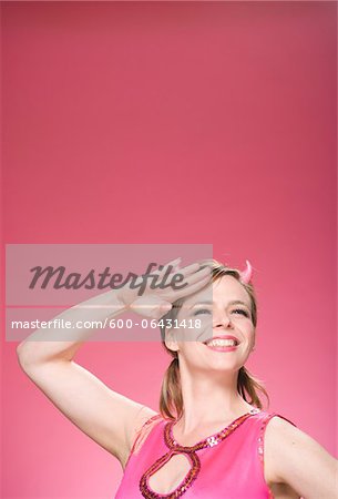 Portrait of Woman Wearing Devil Horns and Saluting