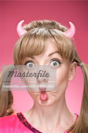 Portrait of Woman Wearing Devil Horns and Making Faces