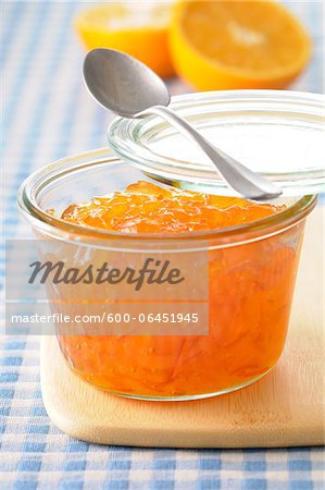 Close-up of Homemade Orange Marmalade with Spoon on Cutting Board